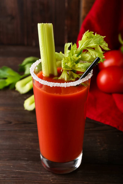 Glass of bloody mary cocktail garnished with cilantro on wooden background - Photo, Image