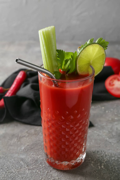 Glass of bloody mary cocktail on grunge background - Foto, afbeelding
