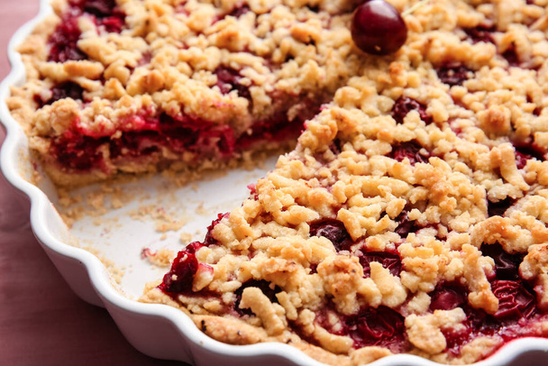 Baking dish with tasty cherry pie on color background, closeup - Foto, afbeelding