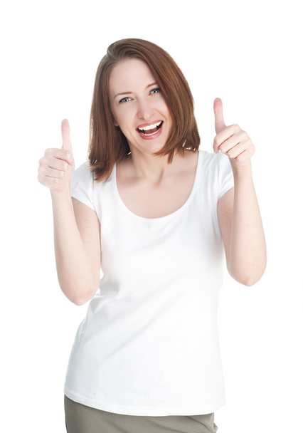 Girl in a white T-shirt shows thumb up isolated on white backgro - 写真・画像