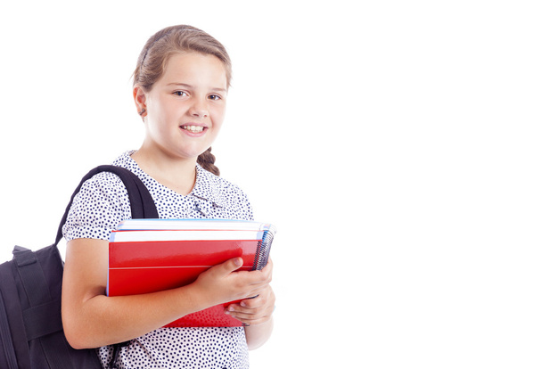 Portrait of a smiling school girl with backpack holding notebook - Foto, Imagem