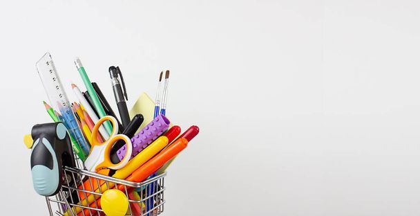 Stationery in a shopping cart. Copy space. Back to school. - Photo, image