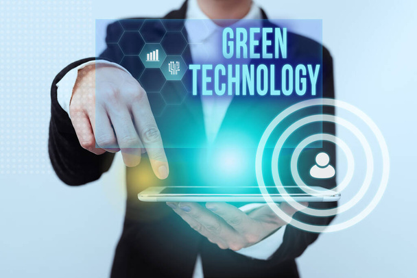 Conceptual caption Green Technology. Word Written on reverse the effects of human activity on the environment Lady In Suit Pointing On Tablet Showing Futuristic Graphic Interface. - Fotoğraf, Görsel