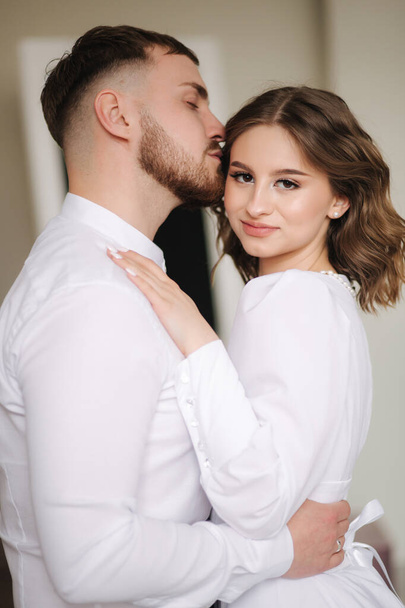 Portrait of beautiful couple kissing. Man and woman in studio. Newlyweds spend time together - Fotografie, Obrázek