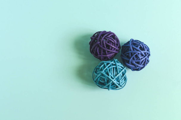 Three balls of colored thread on a colored background. Decor of colored threads on a light background of kopi space - Фото, изображение