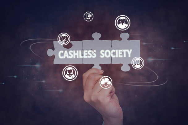 Handwriting text Cashless Society. Business approach financial transactions are executed in electronic format Hand Holding Jigsaw Puzzle Piece Unlocking New Futuristic Technologies. - Foto, imagen