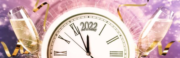 Glasses of sparkling wine, clock, shiny streamers and firework on color background, banner design. Countdown to New Year 2022 - Φωτογραφία, εικόνα