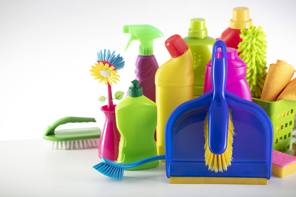 Summer cleaning. Colorful set of bottles with clining liquids and colorful cleaning kit on white background. - Foto, Imagem