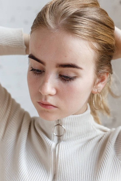 closeup portrait of thoughtful attractive teen model wearing white sweater - Photo, Image
