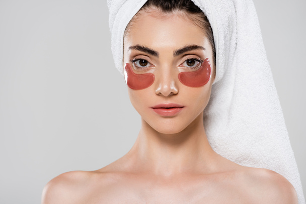 woman with towel on head and eye patches isolated on grey - Foto, Imagem