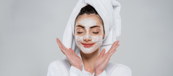 pleased young woman with face scrub isolated on grey, banner - Fotoğraf, Görsel