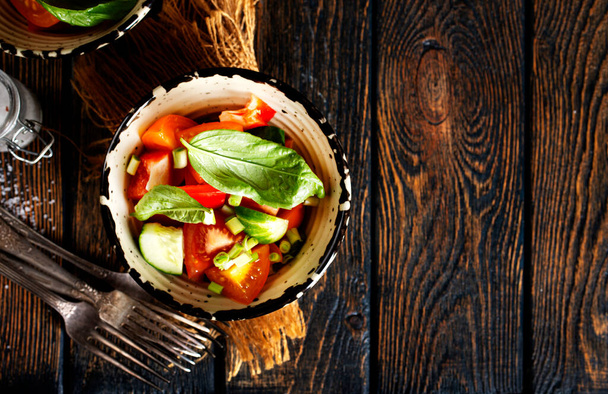 salad with fresh tomato and cucumber in bowls - Фото, зображення