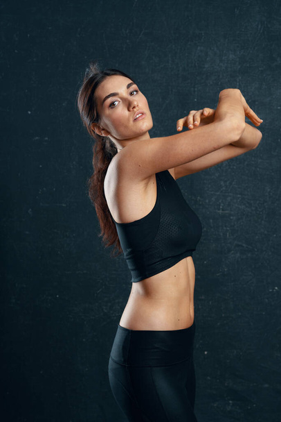 sports woman slim figure workout dark background - Photo, Image