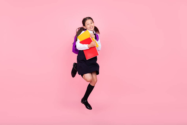 Full body profile side photo of young school girl happy positive smile book education isolated over pink color background - 写真・画像
