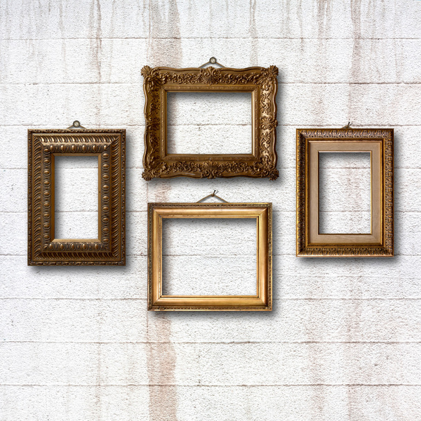 Gilded wooden frames for pictures on old stone wall - Foto, Bild