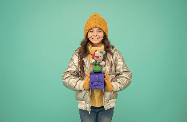 fashion kid in trendy puffer jacket. warm winter clothes. online purchase bonus. happy small girl present. shopping on xmas season. merry christmas. happy new year. Feeling grateful for good gift - Photo, Image