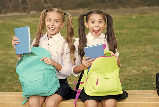 Little school friends girls with backpacks, sincere happiness concept - Photo, Image