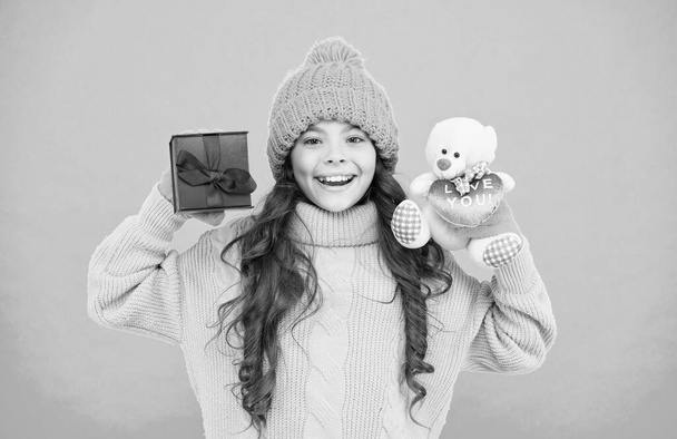 Celebrate birthday. Kid like birthday gift. Feeling grateful for good gift. Surprise and pleasant present. December sale. Cute teddy bear toy. Thank you. Child happy hold gift box. Winter tradition - 写真・画像