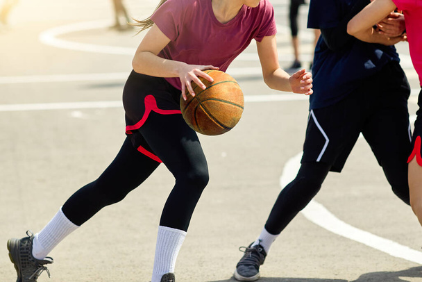 Young girls play street basketball in the summer.  - 写真・画像