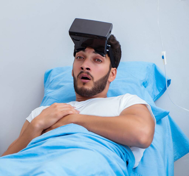 Пацієнт у лікарні з гарнітурою VR окулярів
 - Фото, зображення