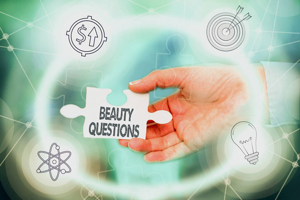 Text caption presenting Beauty Questions. Business idea a sentence or phrase used to find out information Hand Holding Jigsaw Puzzle Piece Unlocking New Futuristic Technologies. - Photo, Image