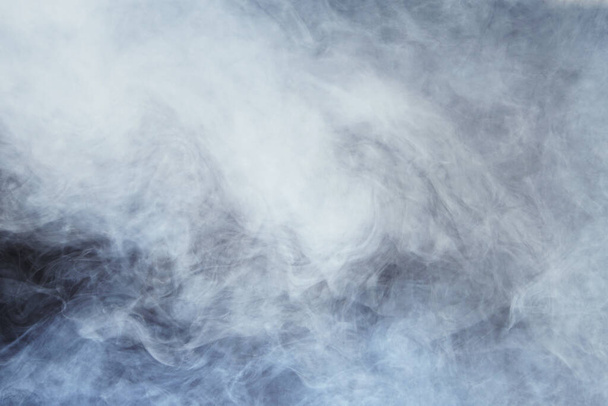 Dense Fluffy Puffs of White Smoke and Fog on Black Background, Abstract Smoke Clouds, All Movement Blurred, intention out of focus, and high low exposure contrast, copy space for text logo - Photo, Image