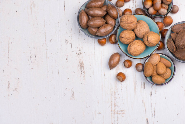 Mix of nuts, hazelnuts, pecan nuts, walnuts, almonds, healthy lifestil - Фото, изображение