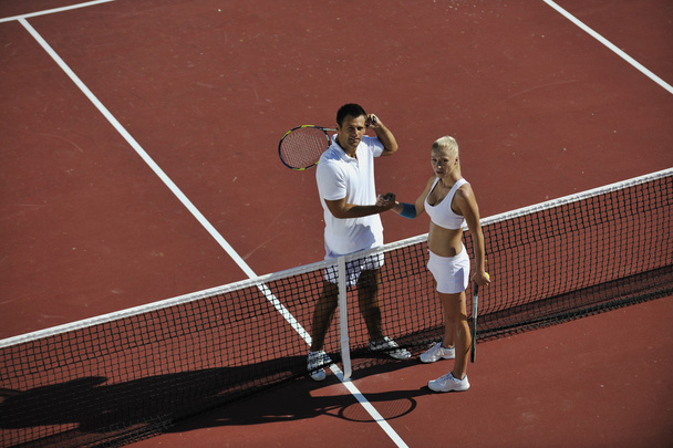 Happy young couple play tennis game outdoor man and woman - Fotoğraf, Görsel
