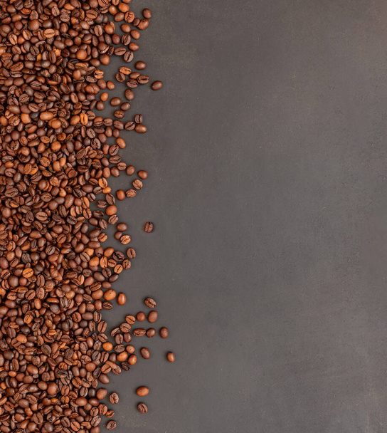 Fresh roasted coffee beans on dark background. Top view. - Photo, Image