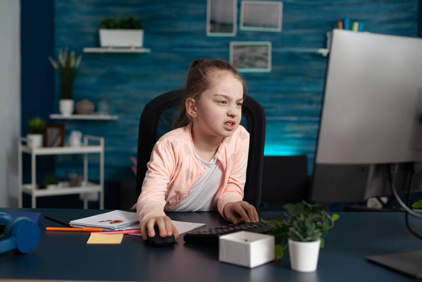 Tired elementary student joining online lesson from home - Foto, Bild