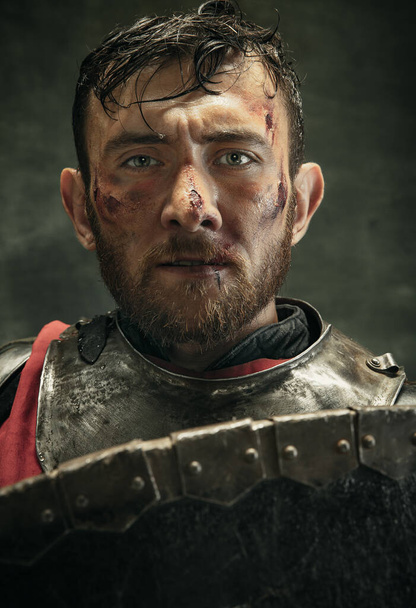 Portrait of one brutal bearded man, medeival warrior or knight with dirty wounded face - Fotoğraf, Görsel