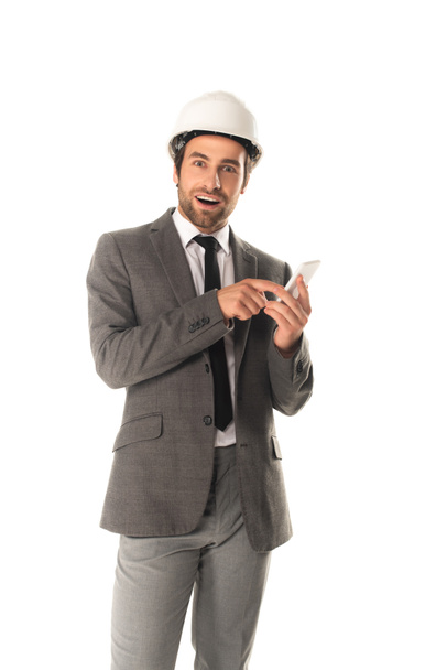 Excited engineer using smartphone isolated on white  - Fotoğraf, Görsel