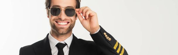 Smiling aviator in sunglasses isolated on white, banner  - 写真・画像