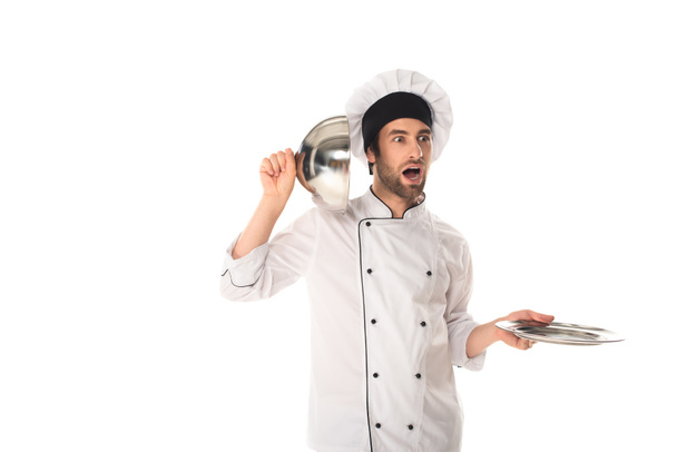 Amazed chef holding cloche near ear isolated on white  - 写真・画像