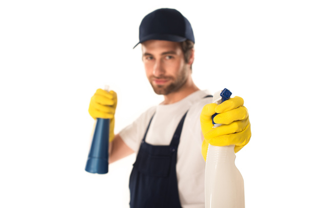 Blurred worker of cleaning company holding detergents isolated on white  - Foto, Bild