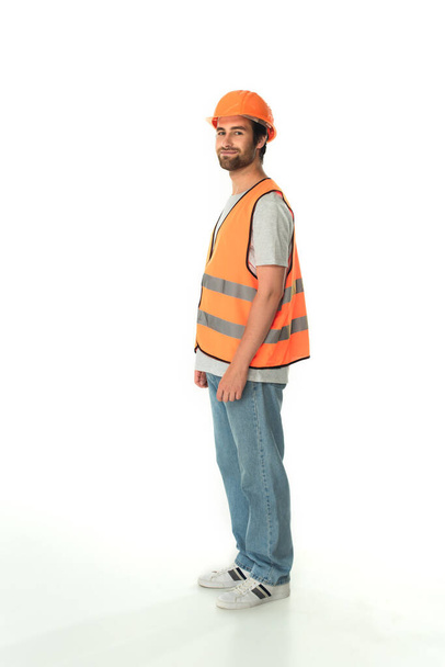 Full length of young builder looking at camera on white background  - Photo, Image