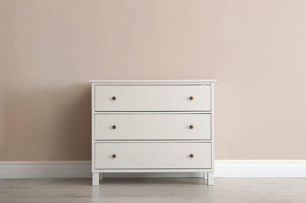 White chest of drawers near beige wall - Foto, Imagem