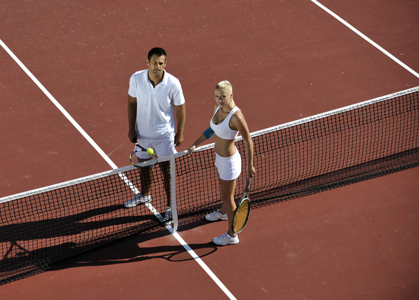 Happy young couple play tennis game outdoor man and woman - Φωτογραφία, εικόνα