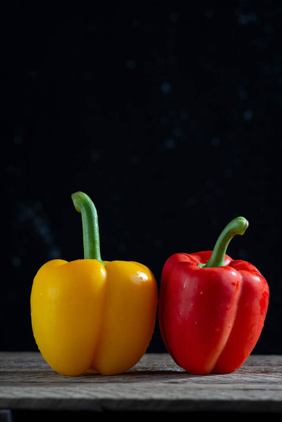 red and yellow peppers for salad, on a wooden table, in a rustic style. minimalistic concept. - Fotoğraf, Görsel