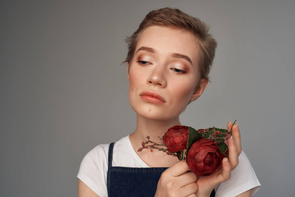 beautiful woman short haircut holding flowers modern style cropped view - Photo, Image