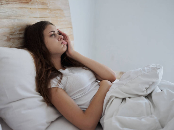 αναστατωμένη γυναίκα ξαπλωμένη στο κρεβάτι αναστατωμένη εν ψυχρώ - Φωτογραφία, εικόνα