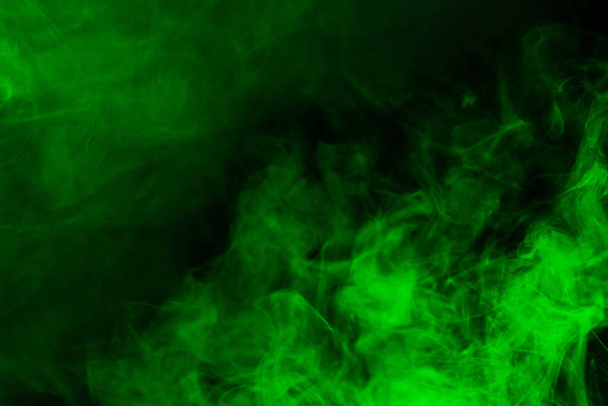 Green steam on a black background. Copy space. - Foto, afbeelding