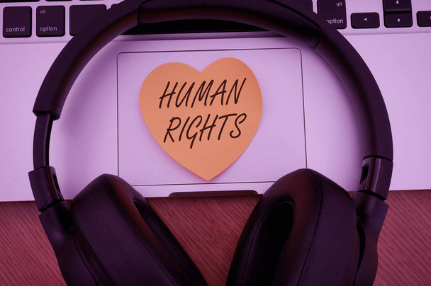 Hand writing sign Human Rights. Business concept the equality of fighting for your rights individuality Blank Notepad Laptop With Pen And Headphones Beside Cup Of Warm Coffee. - Photo, Image
