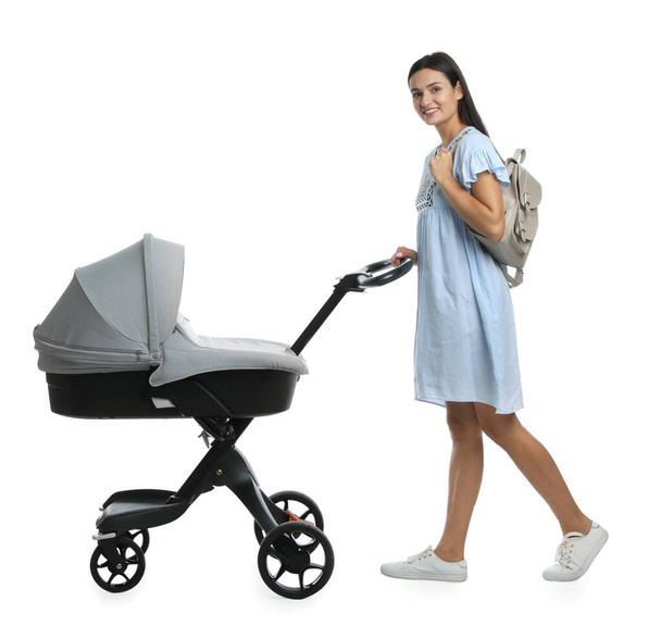 Happy young woman with baby stroller on white background - Foto, Bild