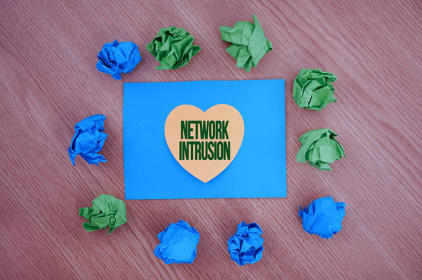Writing displaying text Network Intrusion. Business idea device or software application that monitors a network Colorful Crumpled Papers Circular Pattern Surrounding Heart Shaped Card. - Fotó, kép