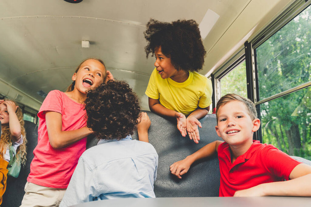 Group of young students attending primary school on a yellow school bus - Elementary school kids ha1ving fun - Φωτογραφία, εικόνα