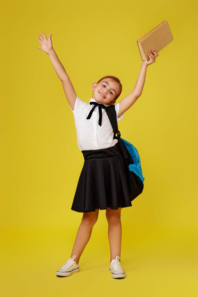 cute happy schoolgirl with backpack and book - Foto, imagen