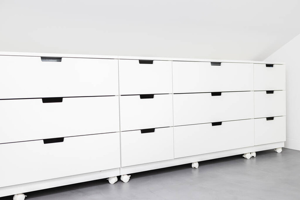 Modern Drawer cabinet with plenty of storage space in a room of a house. Copy space - Photo, Image