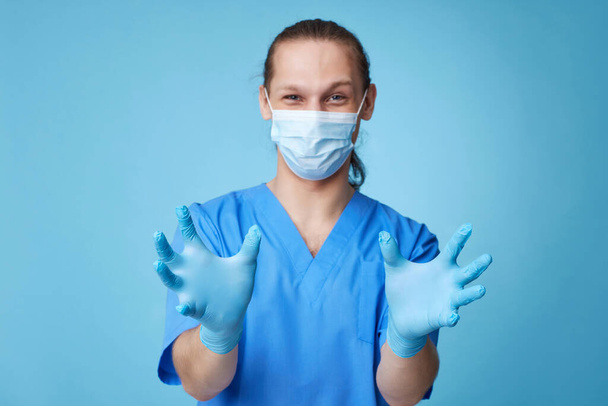 Doctor mammologist touching virtual patient breast on blue background. - Photo, image