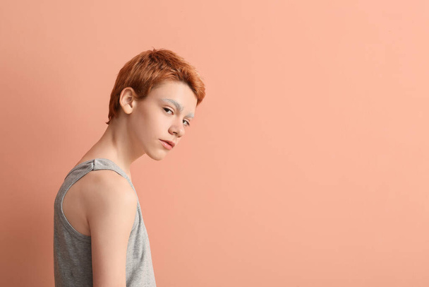 Teenage boy with dyed eyebrows on color background - Photo, Image